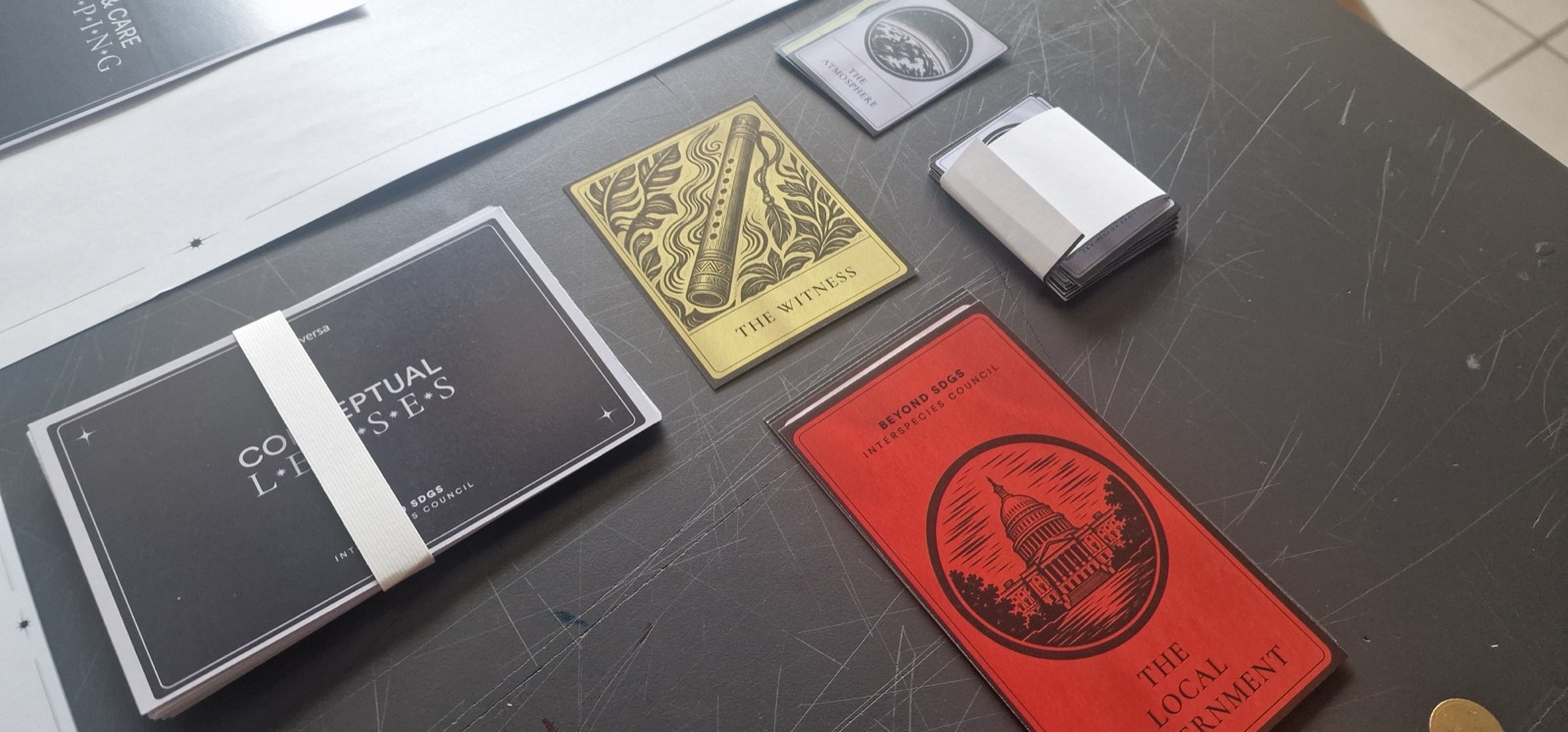 The Conceptual Lenses deck beside the Witness and Local Government role cards